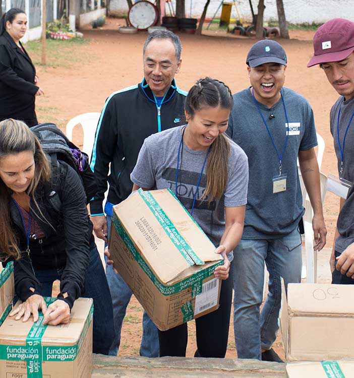 TOMS employees participating in a giving event.