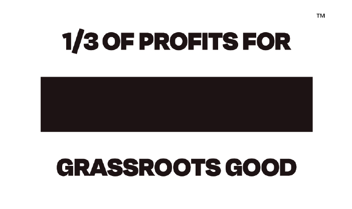 TOMS flag. Text: One third of profits for Grassroots Good. Trademark symbol.