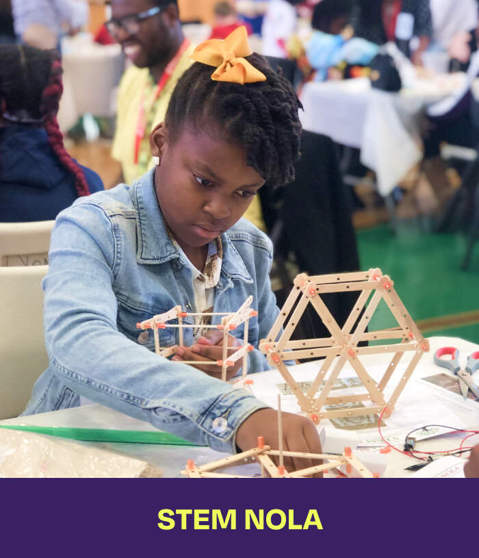 Stem Nola. A girl building a sculpture made out of popsicle sticks.