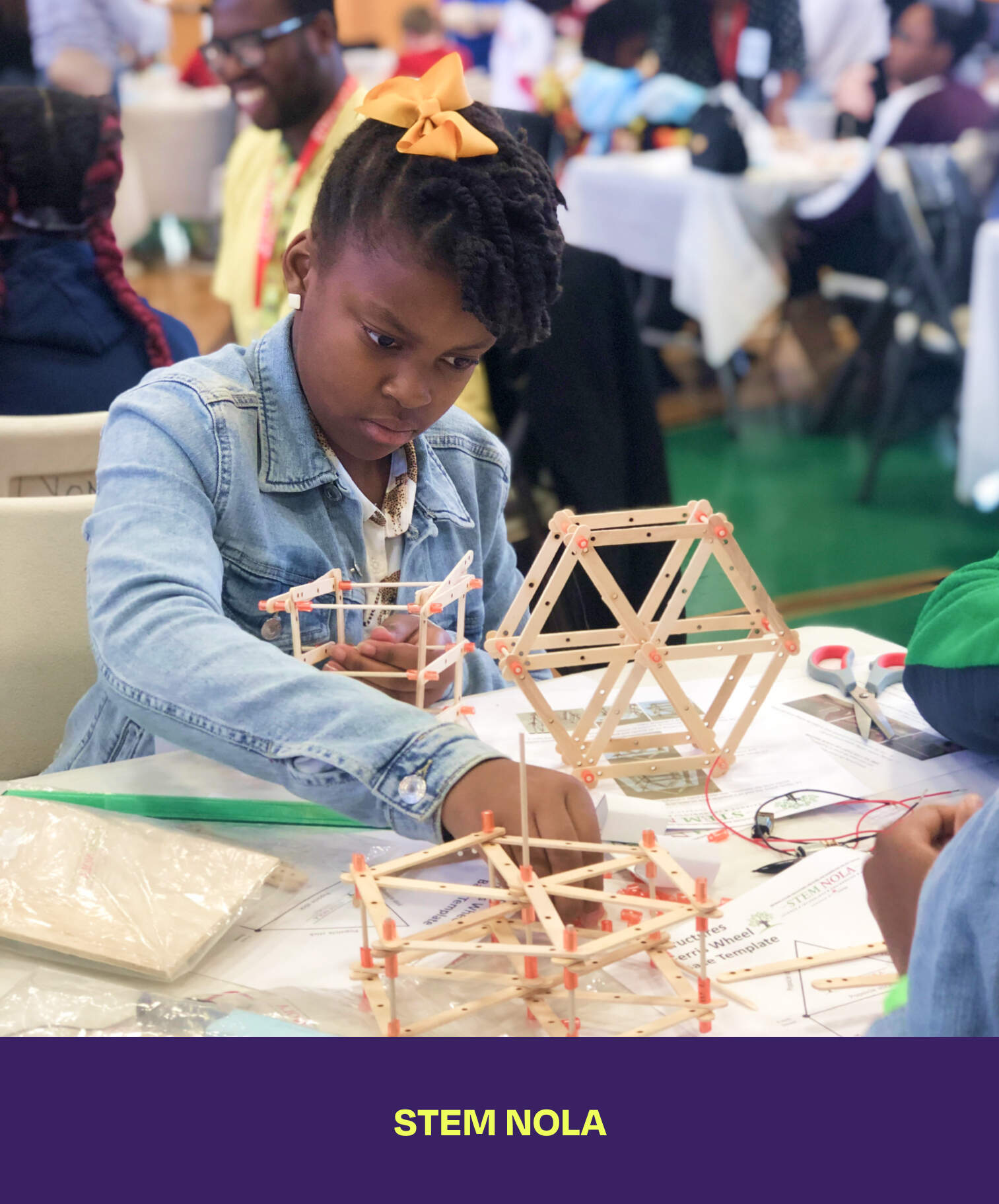 Stem Nola. A girl building a sculpture made out of popsicle sticks.